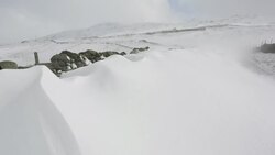 Massive snow drifts block the Kirkstone Pass road above Ambleside in the Lake District, UK during the extreme weather event of late March 2013. shot taken on 25th March 2013. Stock Footage