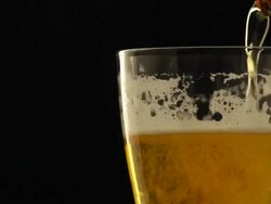 Refreshing beer into rotate glass in dark night Stock Footage