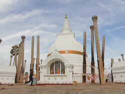 MS Kids and worshippers circle Thuparama Dagoba, the first dagaba built in Sri Lanka after introduction of Buddhism, contains collarbone of Buddha / Anuradhapura, North Central Province, Sri Lanka Stock Footage