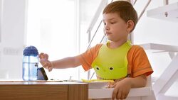 Boy scrolling the phone while eating lunch Stock Footage