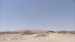 A vast desert surrounds the dry Wadi Kalalat watercourse near the ruins of Berenike, Egypt. Stock Footage