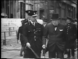 B/W 1940 PAN Winston Churchill walking with military officer outdoors after German attack / London Stock Footage