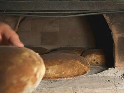 HD: Taking Fresh-Baked Bread From Brick Oven Stock Footage