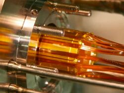 The electrodes (gold) for the ALPHA Penning trap being inserted into the vacuum chamber and cryostat assembly. This is the trap used to combine or 'mix' positrons and antiprotons to make antihydrogen Stock Footage