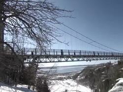MS PAN Shot of Suspension Bridge with Montmorency Falls / Quebec, Canada Stock Footage