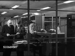 1951: HARVARD UNIVERSITY: AIKEN COMPUTATION LAB: WS Building (now Maxwell Dworkin Computer Science), VS Lab w/ adult males, balding man is computer pioneer, engineer Howard Aiken (1900-1973), & grad students working w/ Mark I & Mark IV calculators Instructional Video