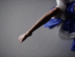 woman with blue silk fabric draped around her lifting foot up to camera Stock Footage