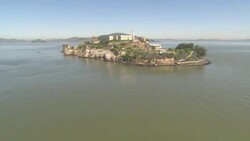 A helicopter flies over the island of Alcatraz. Stock Footage