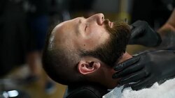 Close-up of beautiful attractive adult man with beard in a barber shop Stock Footage