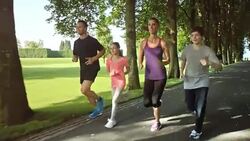 SLO MO TS Family running through tree avenue Stock Footage