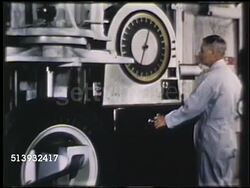 1950: FIRESTONE TIRE TESTING: COLOR:  WS Male worker operating test machine testing tire durability under weight, pressure. MS Male operating machine, reading large gauge. MCU Machine pushing deep against tire. Quality control Instructional Video