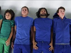 Row of People Lying Down on White Studio Floor Stock Footage