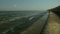 A concrete levee contains Lake Ponchartrain waters. Stock Footage