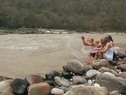 Five senior people playing at riverbank, Ganges River, Rishikesh, Uttarakhand, India Stock Footage