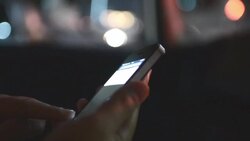 HD:Woman touching smartphone at night time Stock Footage