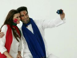 Couple taking picture of themselves with a digital camera in holi festival  Stock Footage