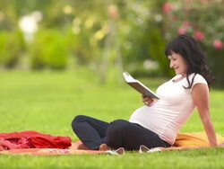 HD: Pregnant Woman Reading In The Park Stock Footage