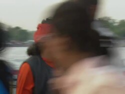 MS PAN Man walking past foot traffic against backdrop of Ganges and Lord Shiva / Haridwar, Uttarakhand, India Stock Footage