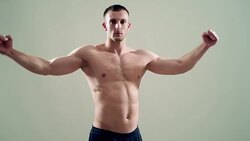 healthy athlete  with nice muscle on grey  background Stock Footage