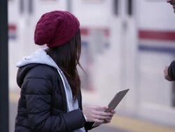 Woman using tablet and has interaction with person walking by. Stock Footage