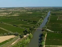 LOW AERIAL, River Aude crossing fields, Aude, France Stock Footage