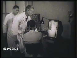 1952: X-RAY: WS Doctors examining, pointing & talking, x-ray of chest cavity. MCU X-ray of chest. X-radiation, xray, hospital, medical Instructional Video