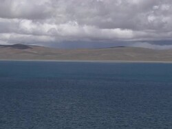 Pull back Rakshastal Lake with mountains and clouds Lhasa Tibet China Stock Footage