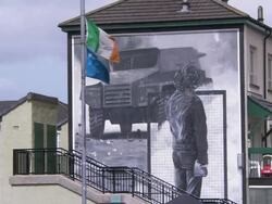 Wall mural, statue and Irish flag, Derry, Northern Ireland Stock Footage