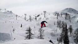 Snowboarder rotates in mid air Stock Footage
