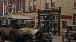Car driving through town, 1930s - reenactment, clip 4 Stock Footage