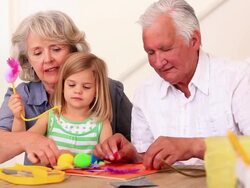 Grandparents making crafts with their granddaughter Stock Footage