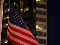 Medium static , An American flag flutters near a high,rise office building. / New York City, New York, USA Stock Footage
