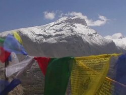 CU, Nepal, Tibetan Buddhist prayer flags with snow capped Annapurna mountains in background Stock Footage