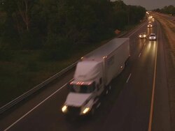 MS Shot of truck and auto traffic on an interstate highway at dusk / Chelsea, Michigan, United States Stock Footage