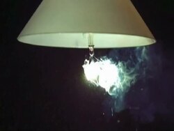 SLO MO - MCU light bulb under shade exploding Stock Footage