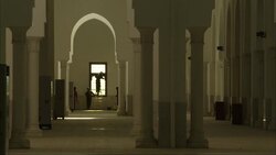 Laborers wash a window and a wall near an arch and room with many columns. Stock Footage