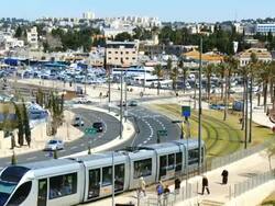 WS TD Shot of traffic moving on road and lightrail train near old city walls / Jerusalem, Judea, Israel Stock Footage