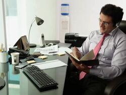 Businessman talking on a headset in an office  Stock Footage