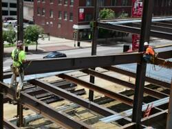 Steelworkers construct a commercial building Stock Footage