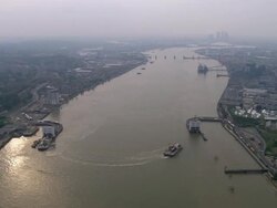 Aerial wide shot pan Woolwich ferry crossing the Thames / London, England Stock Footage
