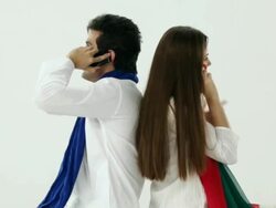 Couple talking on a mobile phone in holi festival  Stock Footage