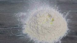 Egg dropping into flour Stock Footage