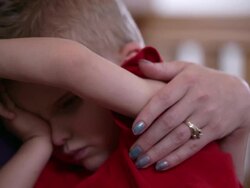 'Head shot of mother holding blind son, tilt down to sun's face' Stock Footage