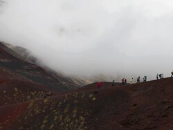 Mount Etna, tourists walking on the volcanic rocks on the mountain Stock Footage