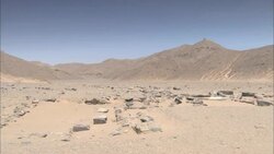 Stones cover a wadi near mountains in the ancient city of Sikait, Egypt. Stock Footage