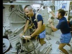Astronaut Don Williams on treadmill on Space Shuttle Atlantis Stock Footage