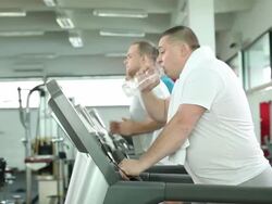 Overweight man on trademill. Stock Footage