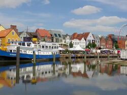 WS View of boats on harbor and view of old town with giant wheel, North Sea North Frisia, / Husum, Schleswig Holstein, Germany Stock Footage