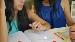 Mature woman home schooling preteen daughter, teaching science class Stock Footage