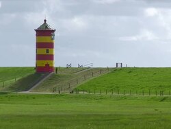 WS Shot of Pilsum lighthouse near Krummhorn at North Sea (Eastern Friesland) / Lower Saxony Stock Footage